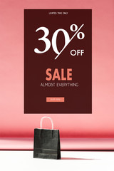 one black shopping bag on pink with copy space, sale banner concept