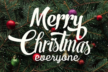 full frame of colorful christmas toys on green pine tree branches with 