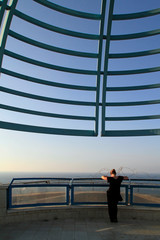 Woman watching the city of Tel Aviv, Israel, from a viewpoint