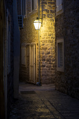 Fototapeta Old street at night illuminated by vintage streetlight. obraz