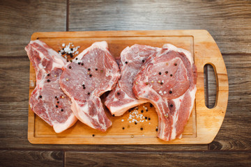 Raw pork on a wooden tray