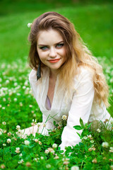 Young blonde woman on green meadow