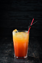 Cocktail Sex on the Beach. Orange juice, vodka, grenadine. On a wooden background. Top view.