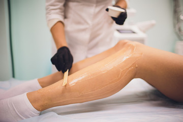 beauty, depilation, epilation, hair removal and people concept - beautiful woman with applicator...