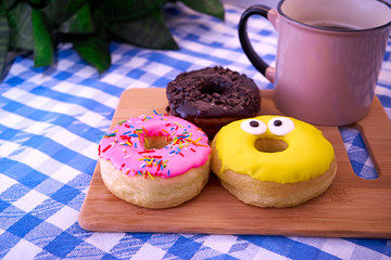 Delicious donuts and coffee are on the table