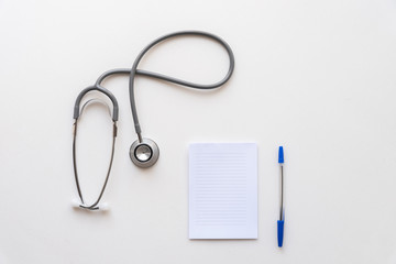 Stethoscope and notebook with pen. Medical concept.