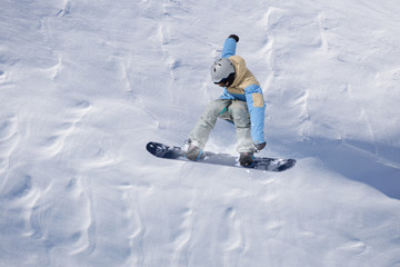 Snowboarder flying on the background of snowy slope. Extreme winter sports, snowboarding. Copy...