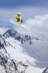 Flying skier on snowy mountains. Extreme winter sport, alpine ski. Copy space.