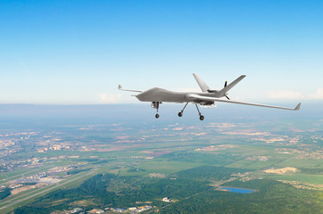 Unmanned military drone uav on patrol air territory at low altitude.