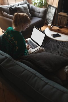 Woman using laptop in living room