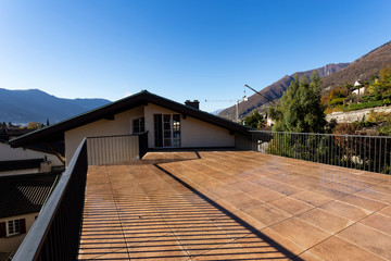 Huge terrace on a sunny day overlooking the Swiss Alps