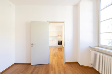 Empty room with parquet and white walls