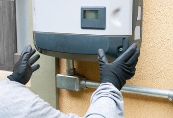 Cleaning and maintenance of the solar inverter. Solar energy concept image.