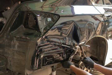 Car body work after the accident by preparing automobile for painting during repair