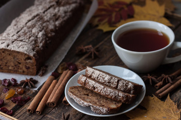 Homemade banana bread with anis star and cinnamon on a dark wooden background