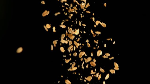 Oats and strawberries falling against black background 4k