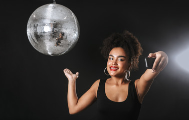 Beautiful african woman standing with silver disco ball