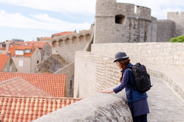 Dubrovnik traveler. Young woman with a camera. Sooting. Hat. Europe travel. 