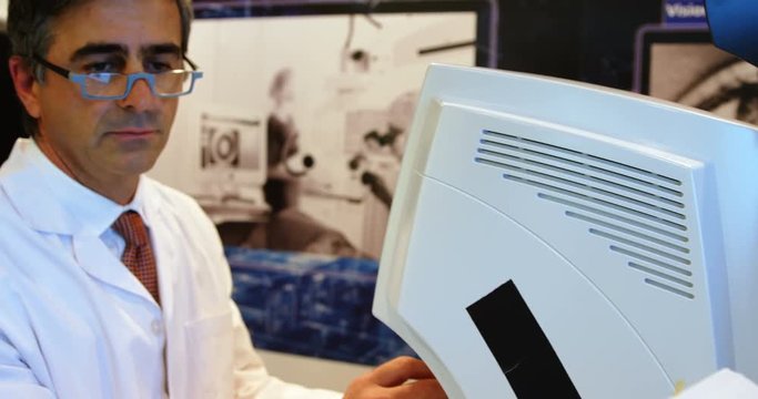 Optometrist examining patient eyes with autorefractors 4k
