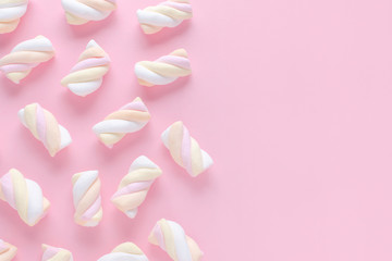 pastel color marshmallow on pink background with copy space