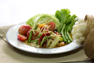 Green papaya Salad (Som Tum Thai) and sticky rice in bamboo container on white background, Thai food