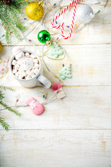 Creative idea for christmas drink, delicious hot chocolate with funny marshmallow snowman, christmas tree, rain dear, santa, on home background with xmas decoration copy space top view