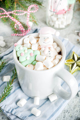Creative idea for christmas drink, delicious hot chocolate with funny marshmallow snowman, christmas tree, rain dear, santa, on home background with xmas decoration copy space top view