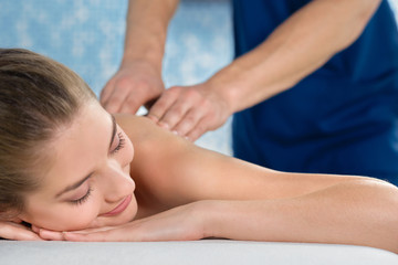 Obraz na płótnie Canvas Closeup of relaxed young woman enjoying procedure in spa