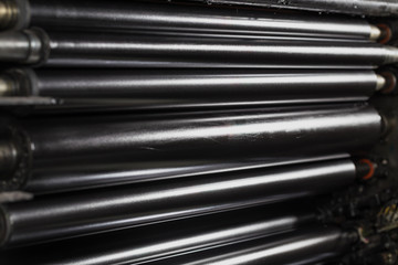 Rolling shafts in the paint of industrial printing machine. Offset printing.