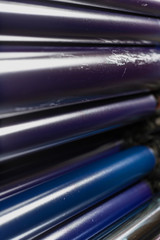 Rolling shafts in the paint of industrial printing machine. Offset printing.