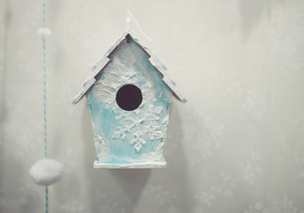 Little birdhouse in spring over blossom cherry tree
