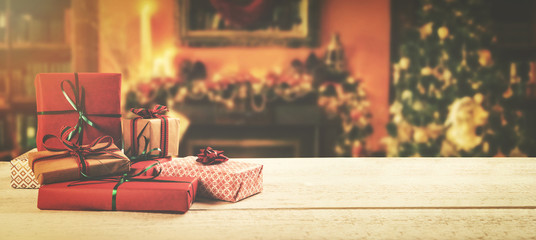 christmas background - wrapped gifts on the table in the decorated room with copy space