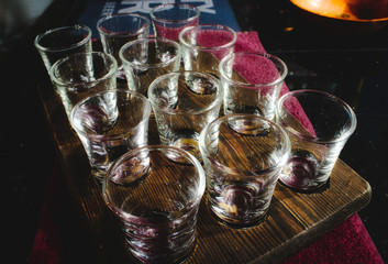 Shot glasses set in a wooden tray in a traditional English pub