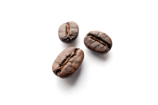 Roasted coffee beans isolated on white background. © Lifestyle Graphic