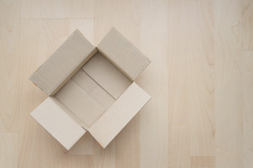 Empty open rectangular cardboard box on wood. Shopping online object background. Shipping parcel object.