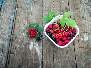 Ripe and juicy berries on an old wooden background.
