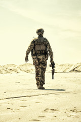 Military contractor, army infantry or rifleman in camouflage uniform and helmet patrolling...