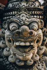 Closeup portrait of Hindu Buddhist traditional stone sculpture. Bali, Indonesia