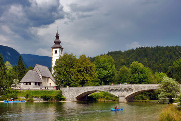 Fototapeta na wymiar Bohinj, Upper Carniola / Slovenia - August 2011: St. John the Baptist's Church in Ribčev Laz in Triglav National Park 