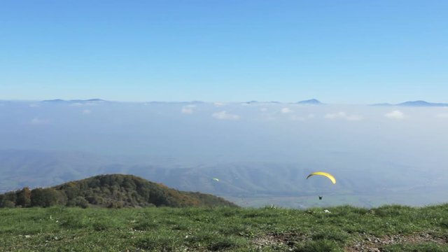 para glider flying a yellow parachute