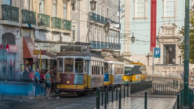 People getting on the tram timelapse, at a station in Luis de Camoes square