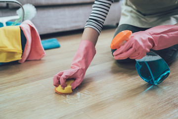 woman with scouring pad cleaning floor © PR Image Factory