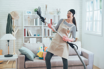 young housewife joyfully doing house chores