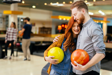 Fototapeta premium Cheerful friends bowling together and having fun