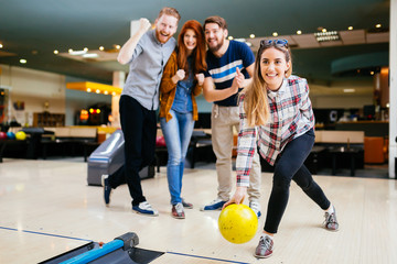 Friends having fun while bowling