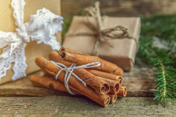 Christmas New Year composition with fir branch pine cones cinnamon sticks gift box on old shabby rustic wooden background. Xmas holiday december decoration to Russian tradition. Copy space