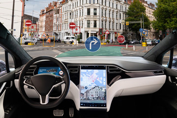 Self driving electric car without driver on a city street. Autonomous mode. Head-up display.