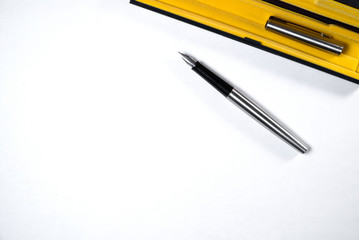 On a white sheet of paper is an ink pen with a cap.