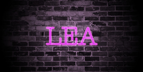 first name Lea in pink neon on brick wall