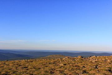 Beautiful panoramic view of the mountains of the Northern Urals. Nature of the Urals in the summer. Sunset in the mountains.